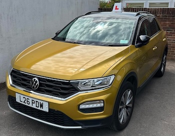 Picture of a yellow driving school car